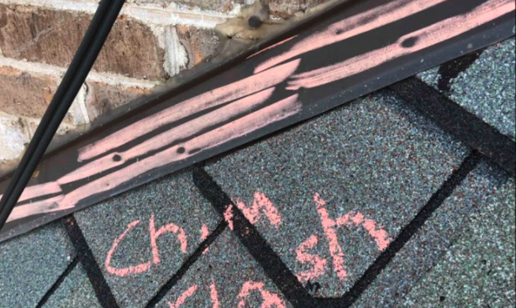 Dent in chimney flashing from hail damage